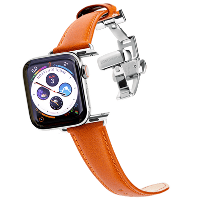 silver apple watch with whiskey brown orange leather band for women